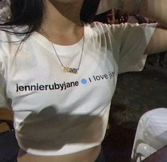 a woman wearing a white t - shirt with the words jennyie ruubanne on it