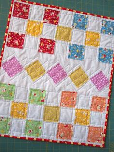 a patchwork quilt is laying on the table