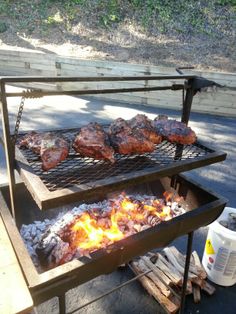 some meat is cooking on a grill outside