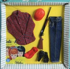 a doll's clothes and accessories are displayed in a box