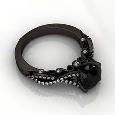 an unusual black diamond ring on a white background with lots of diamonds in the middle