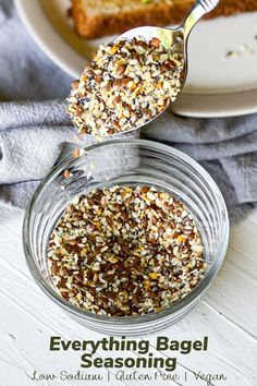 a spoonful of everything bagel seasoning on a plate with bread in the background