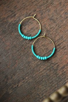 Minimalist summer earrings with turquoise green glass seed beads and gold tone stainless steel round hoop earrings. Earring hooks are from nickel free and lead free metal. Perfect jewelry for everyday wear or a great gift for someone special! Diameter of hoops is 25 mm Other earrings of my shop you can see here: https://www.etsy.com/shop/NaTavelli?section_id=13757927 Thanks for visit. Beads Earrings Gold, Everyday Earrings Simple, Turquoise Earrings Gold, Seed Beads Earrings, Stone Bead Jewelry, Minimalist Summer, Vert Turquoise, Summer Earrings, Beads Earrings