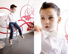 a young boy sitting on a stool in front of a wall