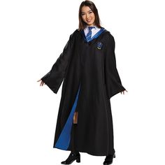 a woman dressed in a harry potter robe with her hands on her hips, posing for the camera