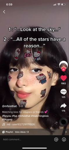 the girl has her face painted with hello kitty stickers