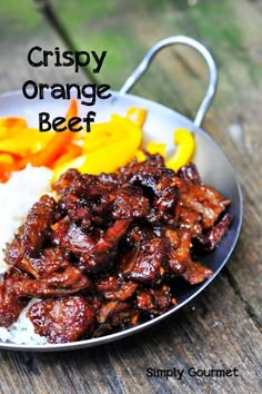 an image of a plate of food with rice and peppers on it that says crispy orange beef