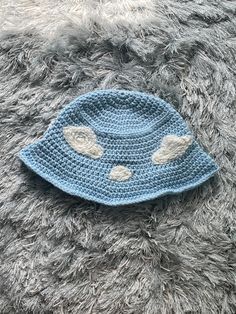 Hand-crocheted baby blue bucket hat with surface-stitched clouds, made with soft non-irritating yarn Blue Bucket Hat, Crochet Bucket Hat, Blue Hat, Baby Hats, Baby Blue, Hand Crochet, Bucket Hat, Caps Hats, Accessories Hats