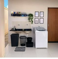 a small bathroom with a sink, washer and dryer