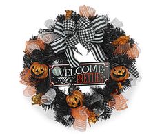 a wreath that says welcome to the prettiies with pumpkins and black mesh