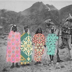 an old photo of four people in native clothing with camels and mountains in the background