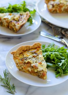 a slice of quiche on a plate with greens