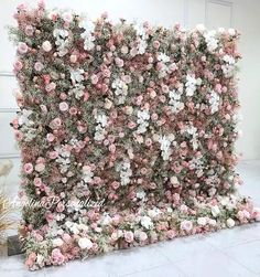 an artificial flower wall is shown with pink and white flowers