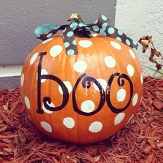 a polka dot pumpkin with the word boo painted on it