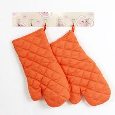 an orange oven mitt hanging on a hook