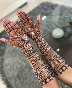 two hands with henna designs on them