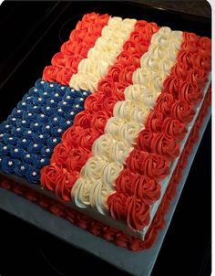 an american flag cake with red, white and blue frosting on it's side