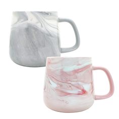 two marbled coffee mugs sitting next to each other