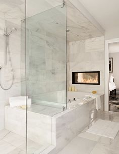 a bathroom with a fireplace in the wall and a large bathtub next to it