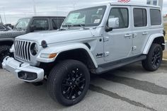 a white jeep parked in a parking lot