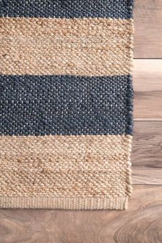 a blue and beige rug on top of a wooden floor