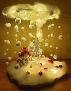 a snowman is sitting on top of a cloud with lights in the shape of christmas trees