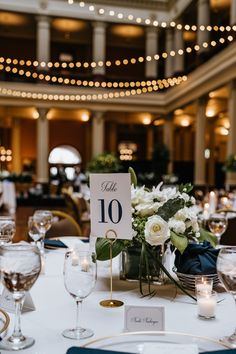 the table is set with white flowers and candles