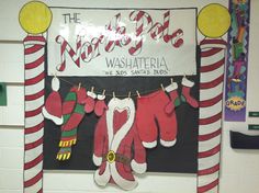 a christmas bulletin board with santa's stockings hanging from it