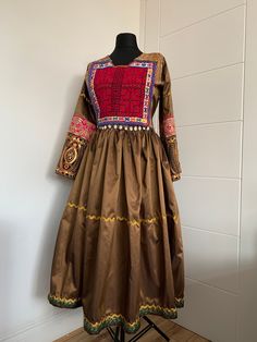 "This is stunning vintage-style traditional Afghan dress is made from silk. The dress is suitable for all occasions. One size fits many as it can be tied from the back although it is most suited to medium size. Dimensions: Sleeve length:22\" Skirt length:31\" Chest width:22\"" Traditional Embroidered Silk Maxi Dress, Traditional Long Beige Dress, Traditional Brown Dresses For Festivals, Fitted Pink Dress With Traditional Patterns, Festive Brown Bohemian Dress, Festive Bohemian Brown Dress, Bohemian Silk Dress For Traditional Ceremonies, Brown Anarkali Dress For Festive Occasions, Festive Brown Anarkali Dress