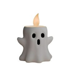 a small white candle with black eyes and a ghost face on it's side