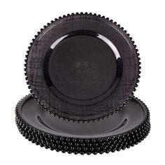 black beaded plates stacked on top of each other in front of a white background