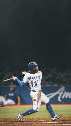 a baseball player swinging a bat on top of a field