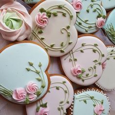 decorated cookies with pink roses and green leaves