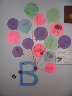 a child's handprinted balloon with the letter b on it is displayed