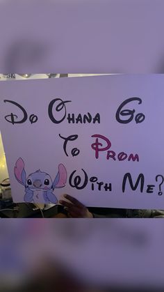 a person holding up a sign that says do china go to prom with me?