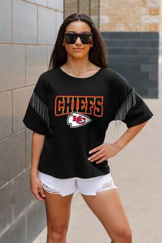 KANSAS CITY CHIEFS IRRESISTIBLE SHORT SLEEVE RHINESTONE FRINGE TEE Casual Black Fringe Tops, Trendy Short Sleeve T-shirt With Fringe, Trendy Short Sleeve Fringe T-shirt, Casual Short Sleeve Fringe T-shirt, Trendy Fringe Short Sleeve T-shirt, Casual Crew Neck T-shirt With Fringe, Trendy Black Tops With Rhinestone Fringe, Black T-shirt For Game Day In Summer, Casual Cotton T-shirt With Fringe