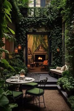 an outdoor dining area with green plants on the walls and tables set for four, surrounded by greenery