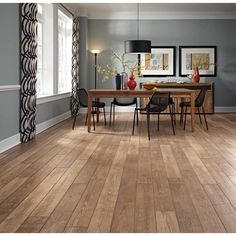 a dining room with wood floors and gray walls