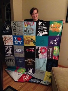 a woman holding up a quilt made from t - shirts