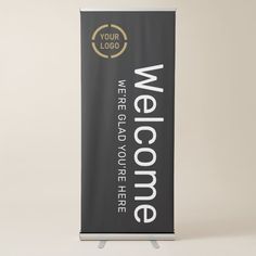 a black and white welcome sign on a stand