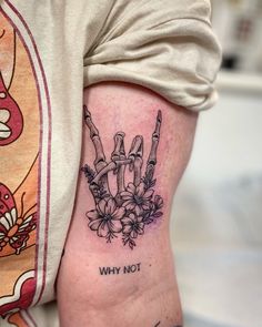 a person with a tattoo on their arm that says, why not? and flowers