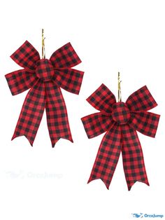 two red and black plaid bows hanging from hooks on a white background with the words christmas written below them