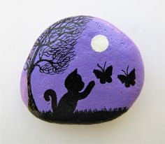 an elephant painted on top of a rock with trees and moon in the sky behind it