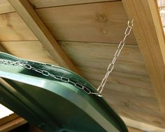 a chain hanging from the side of a green bucket