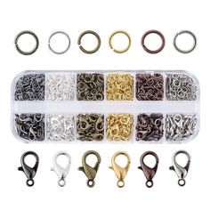 various types of rings and hooks in a plastic container on a white background with clippings