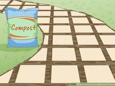 a bag of compostt sitting on top of a sidewalk next to a patch of grass