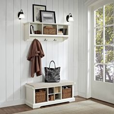 a white bench with two baskets and a coat rack