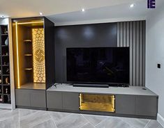 a living room with a large flat screen tv on top of a wooden entertainment center