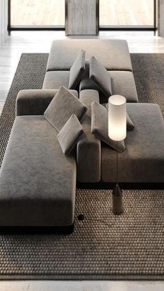 a large gray couch sitting on top of a rug