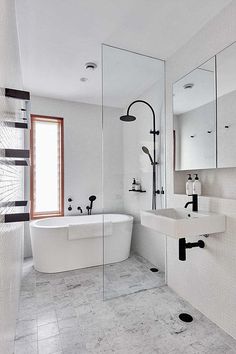 a large white bathroom with black and white fixtures